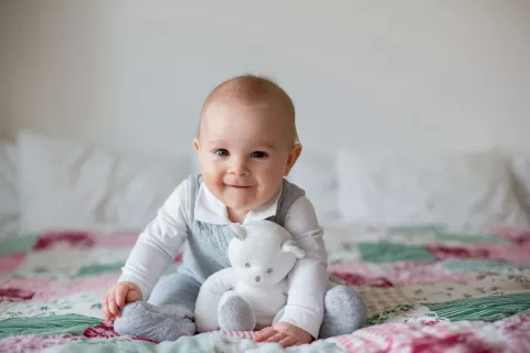 baby holding bed