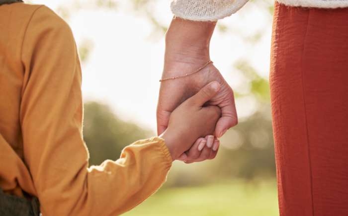 Parent and child holding hands