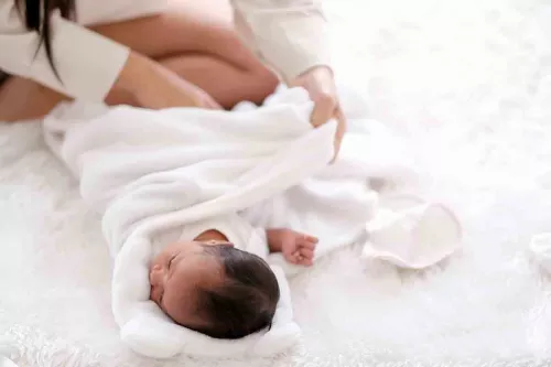 https://www.familyeducation.com/sites/default/files/styles/webp_image/public/2020-11/Ollie%20Swaddle_featured.jpg.webp?itok=62NZPe94